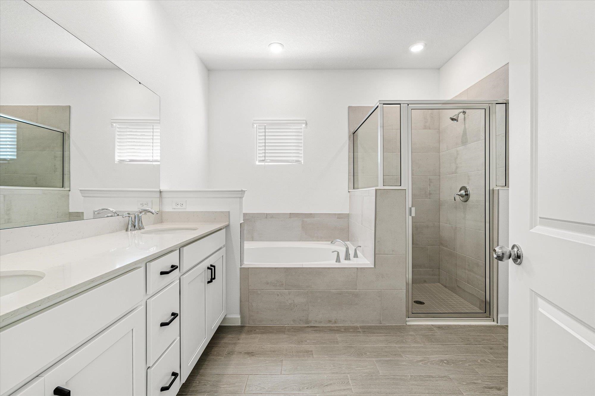 89 Kingsley Pk Way St. Augustine, FL 32084 - Photo 17 of 67 a bathroom with a granite countertop sink mirror shower and bathtub