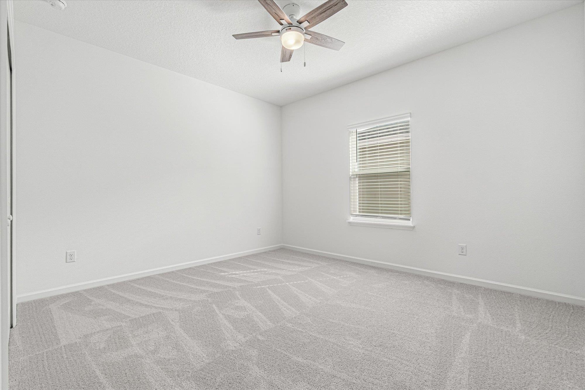 89 Kingsley Pk Way St. Augustine, FL 32084 - Photo 25 of 67 an empty room with a ceiling fan and window