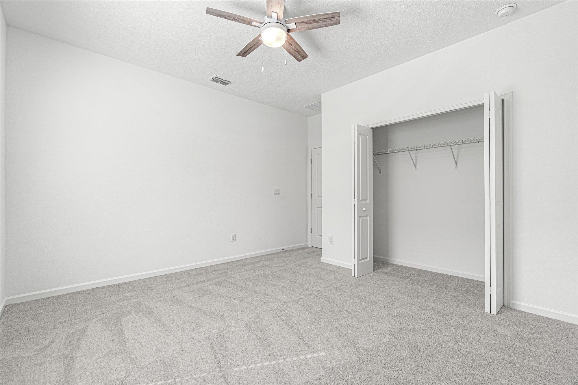 89 Kingsley Pk Way St. Augustine, FL 32084 - Photo 26 of 67 an empty room with closet and windows