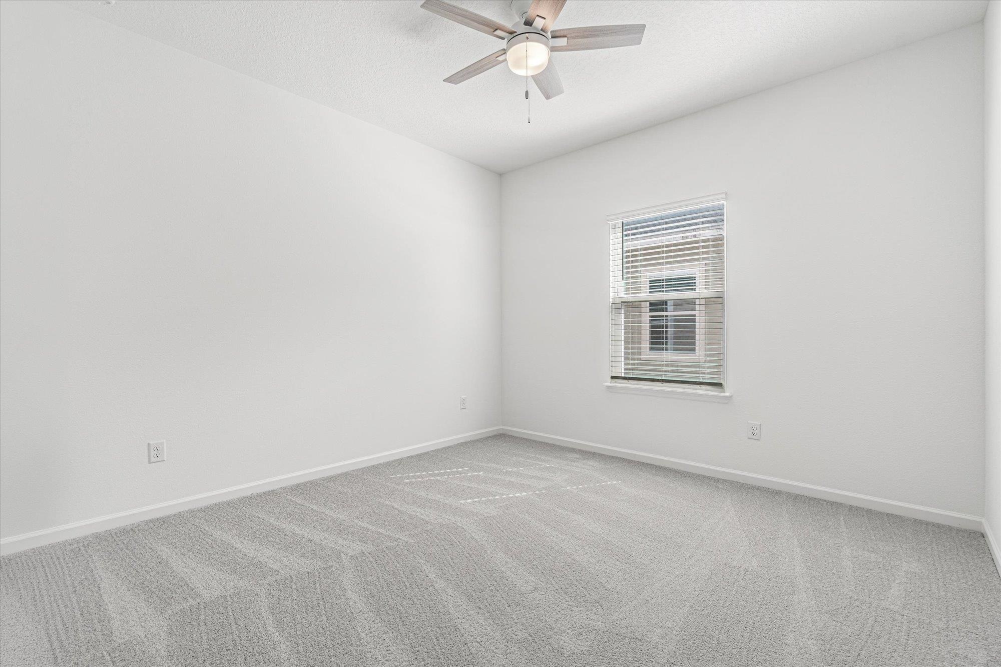 89 Kingsley Pk Way St. Augustine, FL 32084 - Photo 29 of 67 an empty room with a window and ceiling fan