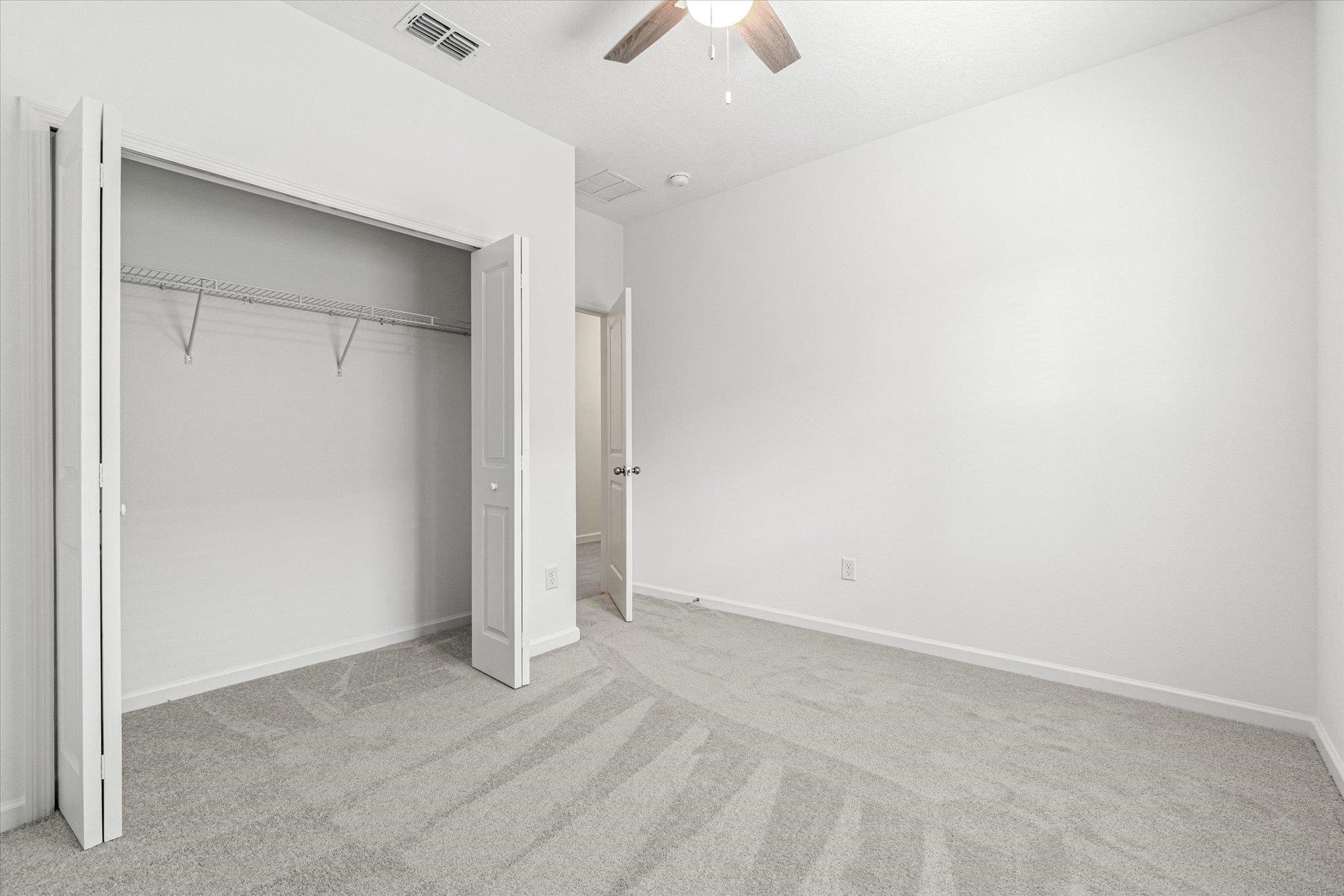 89 Kingsley Pk Way St. Augustine, FL 32084 - Photo 32 of 67 an empty room with a ceiling fan and a window