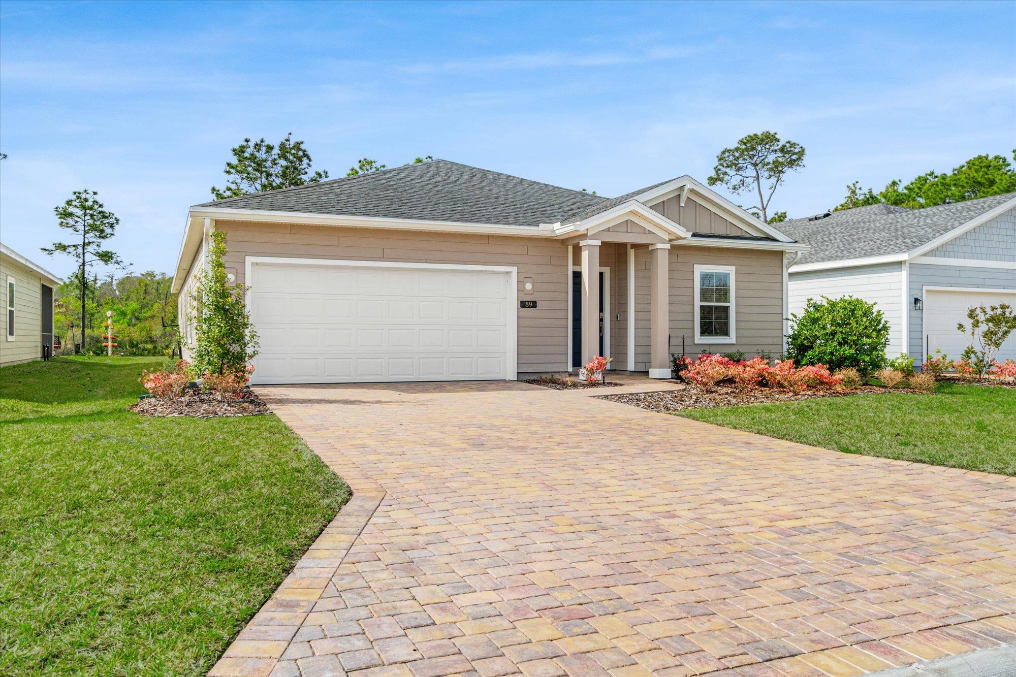 89 Kingsley Pk Way St. Augustine, FL 32084 - Photo 50 of 67 a front view of a house with a garden and plants