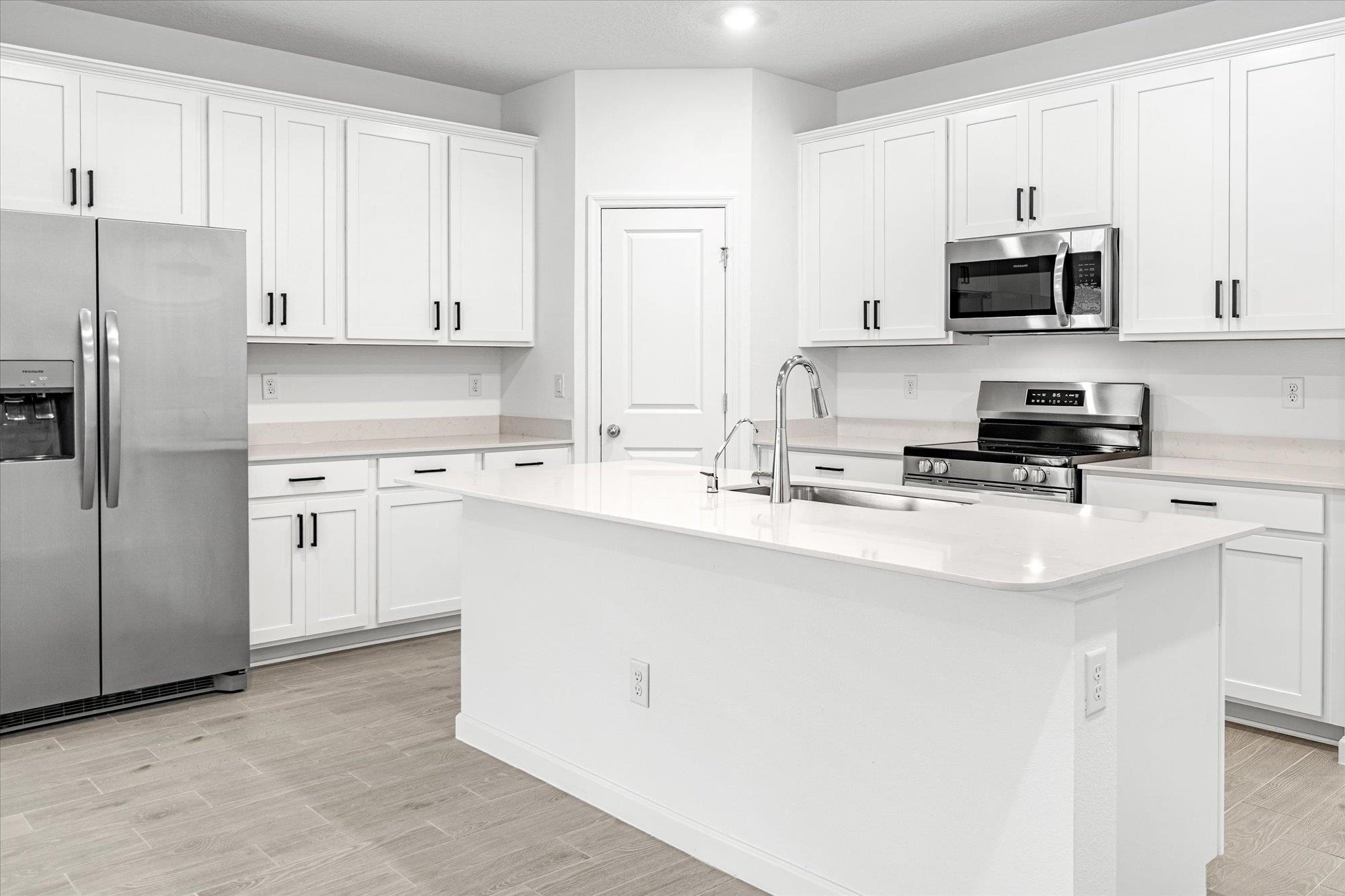 89 Kingsley Pk Way St. Augustine, FL 32084 - Photo 5 of 67 a kitchen with stainless steel appliances a refrigerator stove microwave and sink