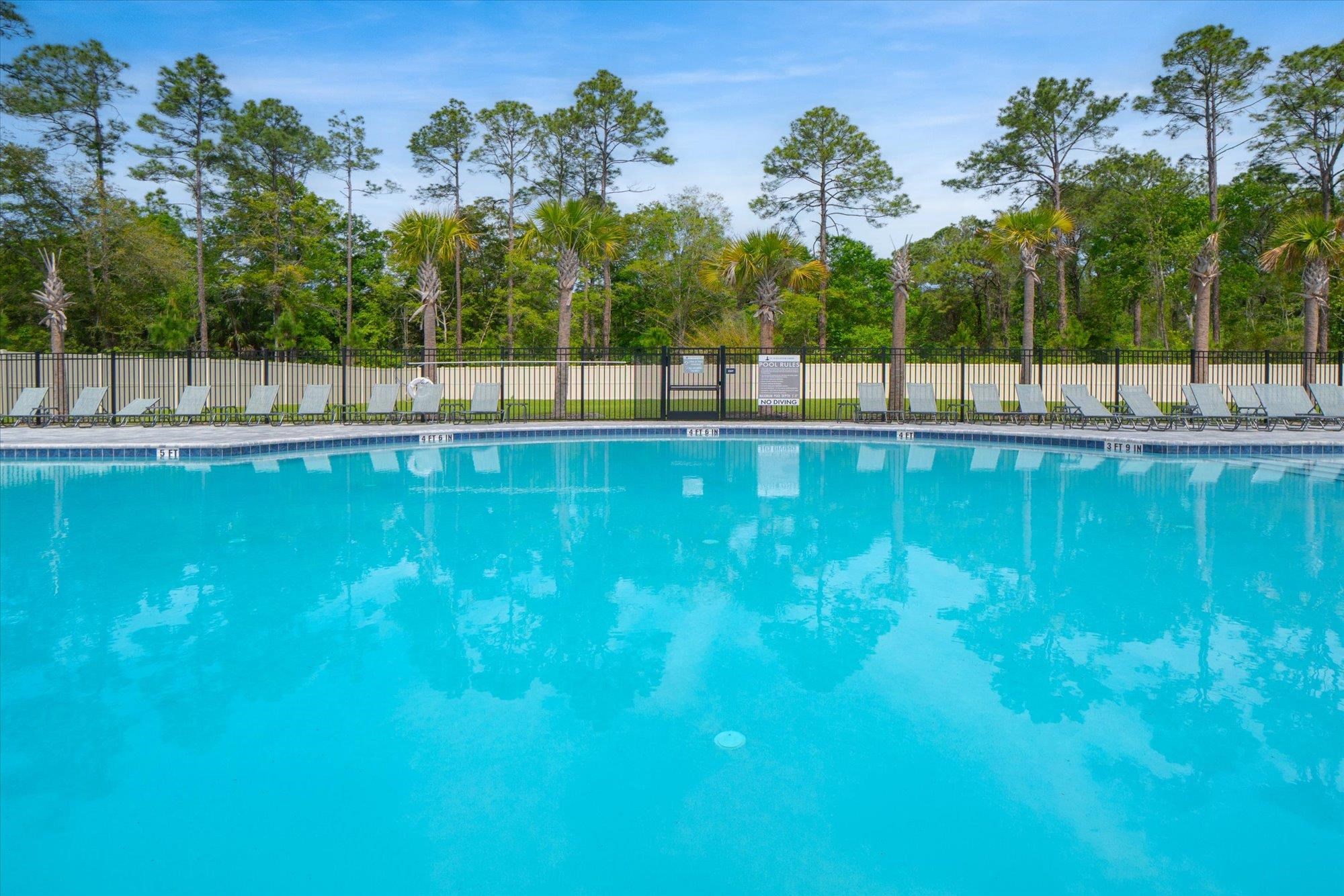 89 Kingsley Pk Way St. Augustine, FL 32084 - Photo 62 of 67 Community pool with a patio area and view of wooded area