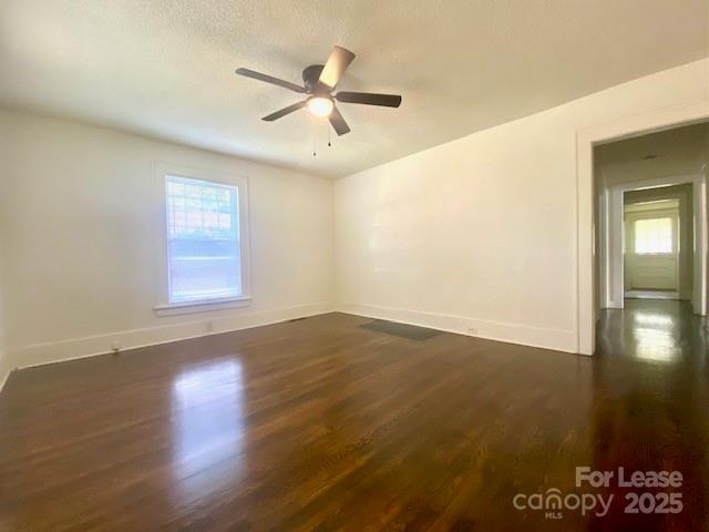 154 Franklin Avenue Northwest Concord, NC 28025 - Photo 5 of 14 an empty room with wooden floor fan and windows