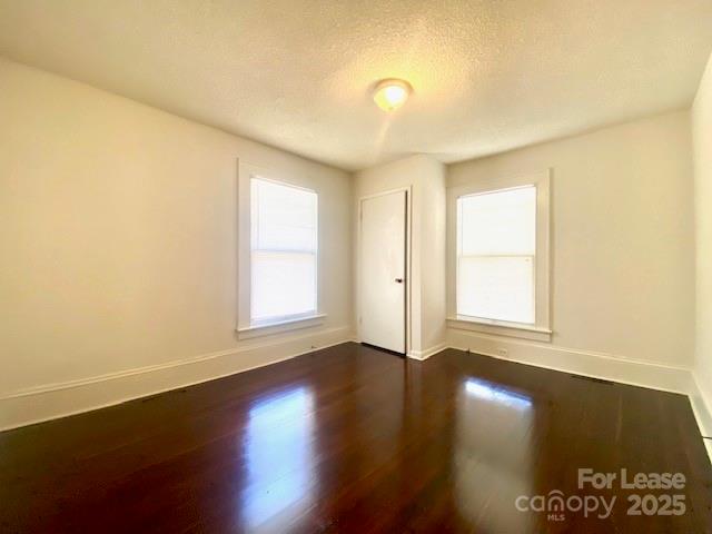 154 Franklin Avenue Northwest Concord, NC 28025 - Photo 7 of 14 an empty room with wooden floor and windows