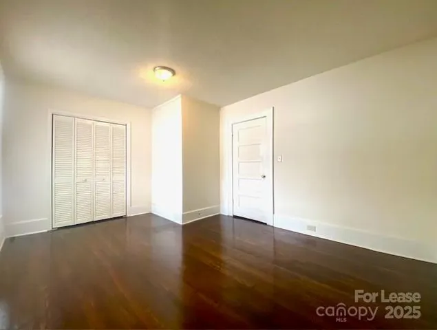 a view of an empty room and wooden floor