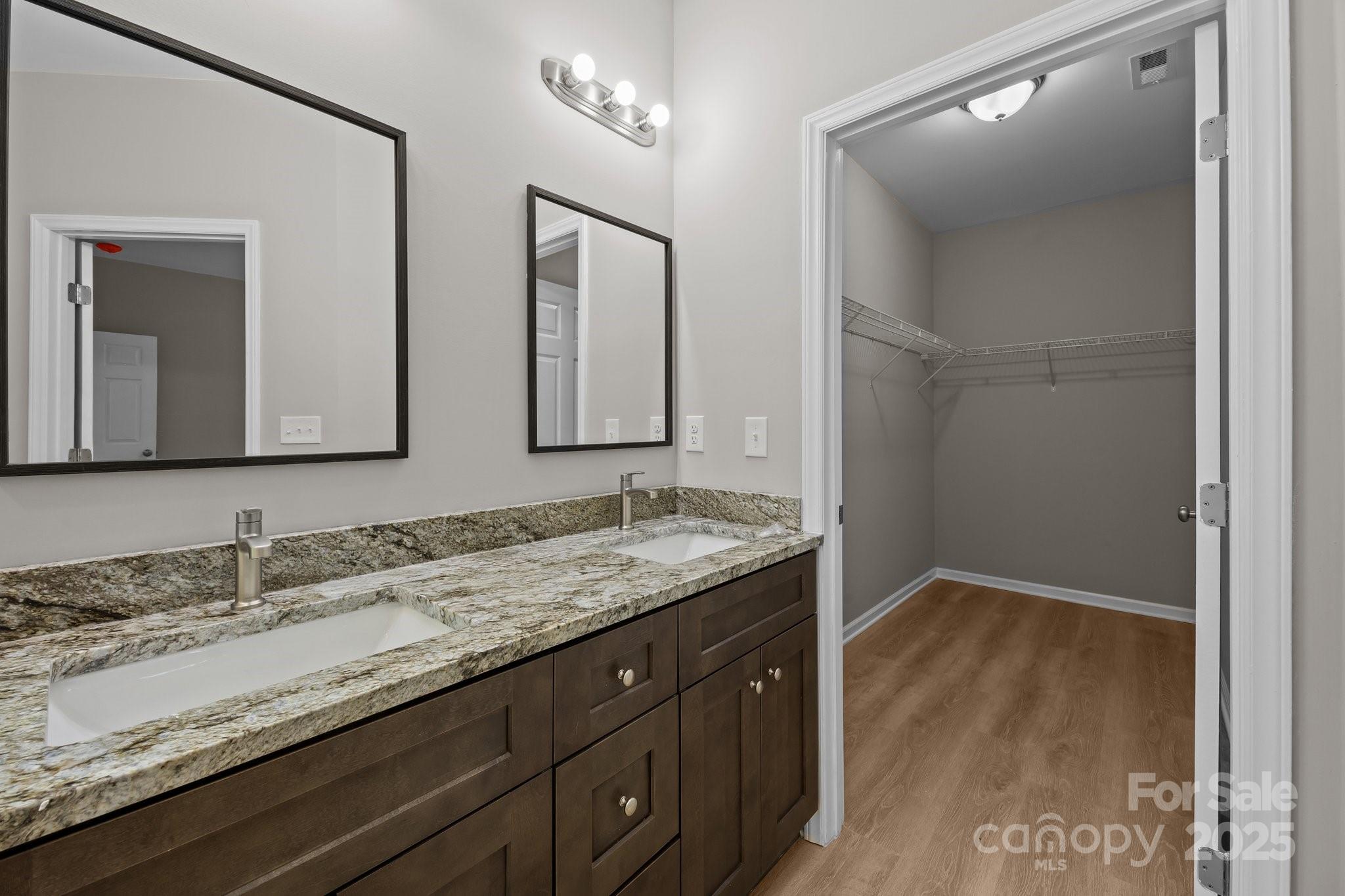 126 Aurora Boulevard Matthews, NC 28105 - Photo 12 of 41 a bathroom with a granite countertop sink a large mirror and a