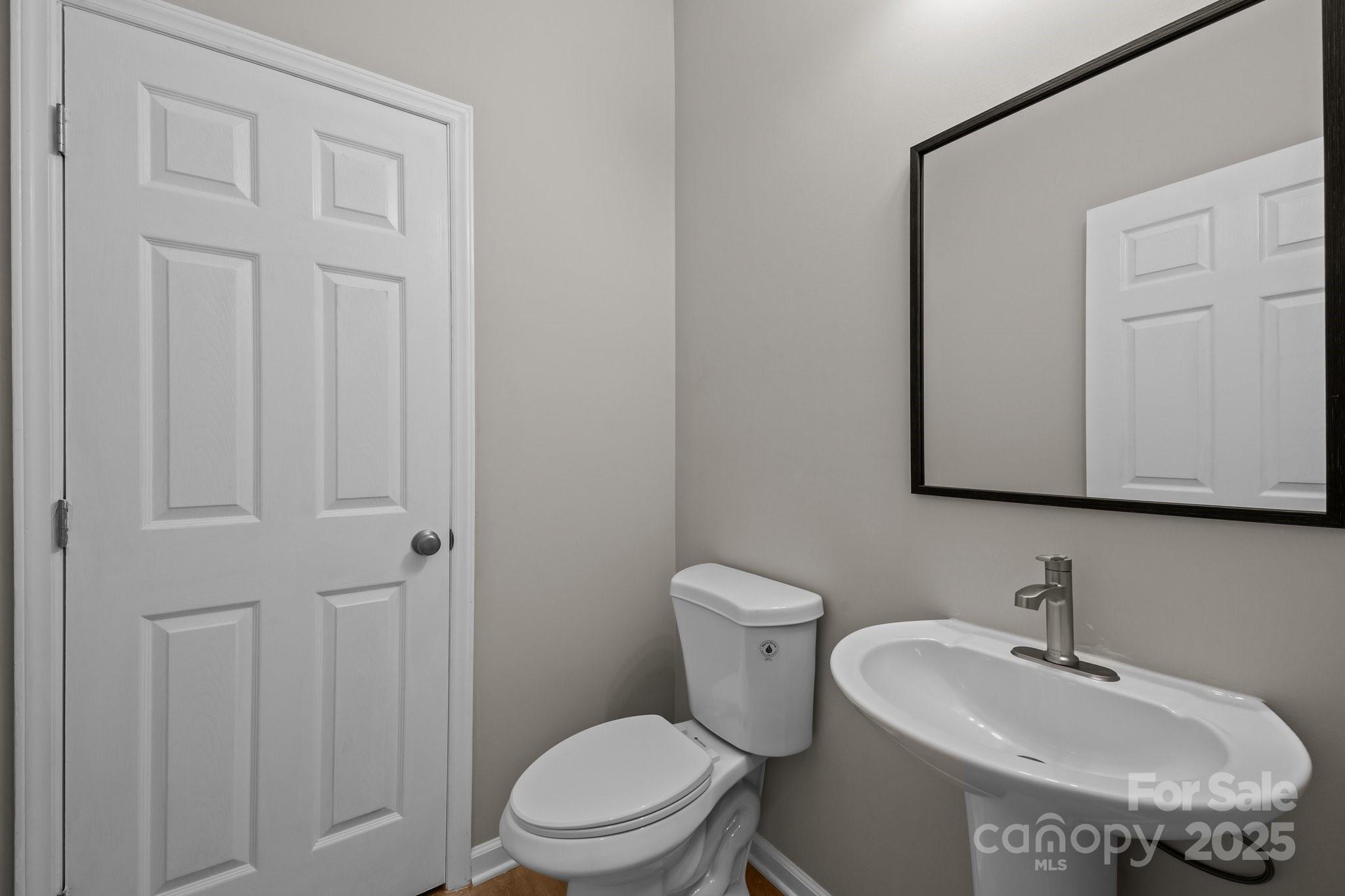 126 Aurora Boulevard Matthews, NC 28105 - Photo 15 of 41 a bathroom with a toilet a sink and mirror