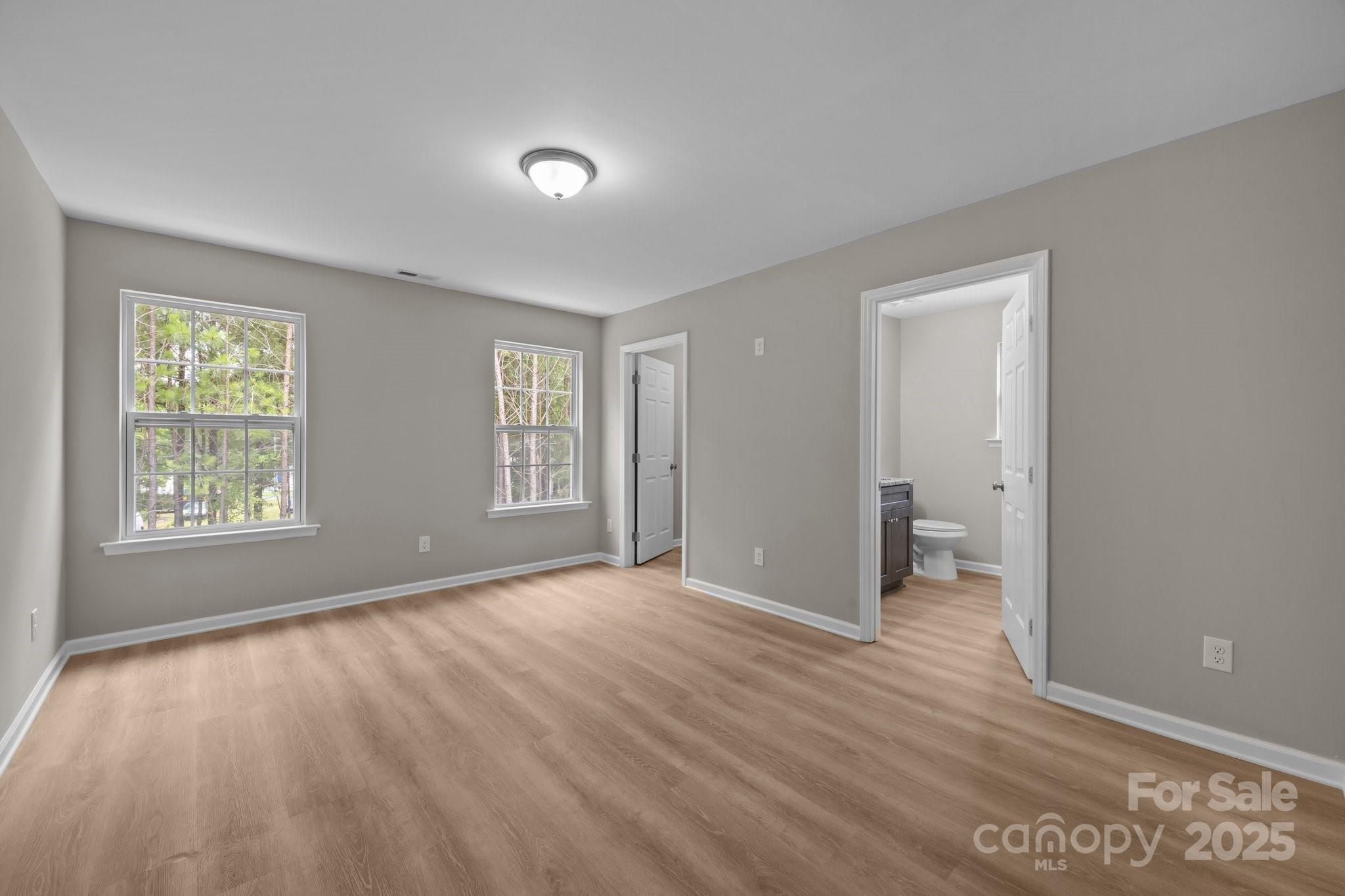 126 Aurora Boulevard Matthews, NC 28105 - Photo 18 of 41 a view of an empty room with wooden floor and a window