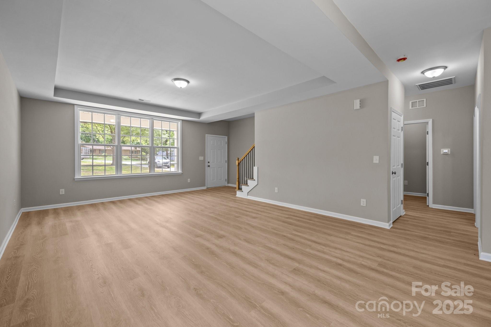 126 Aurora Boulevard Matthews, NC 28105 - Photo 7 of 41 wooden floor in an empty room with a window