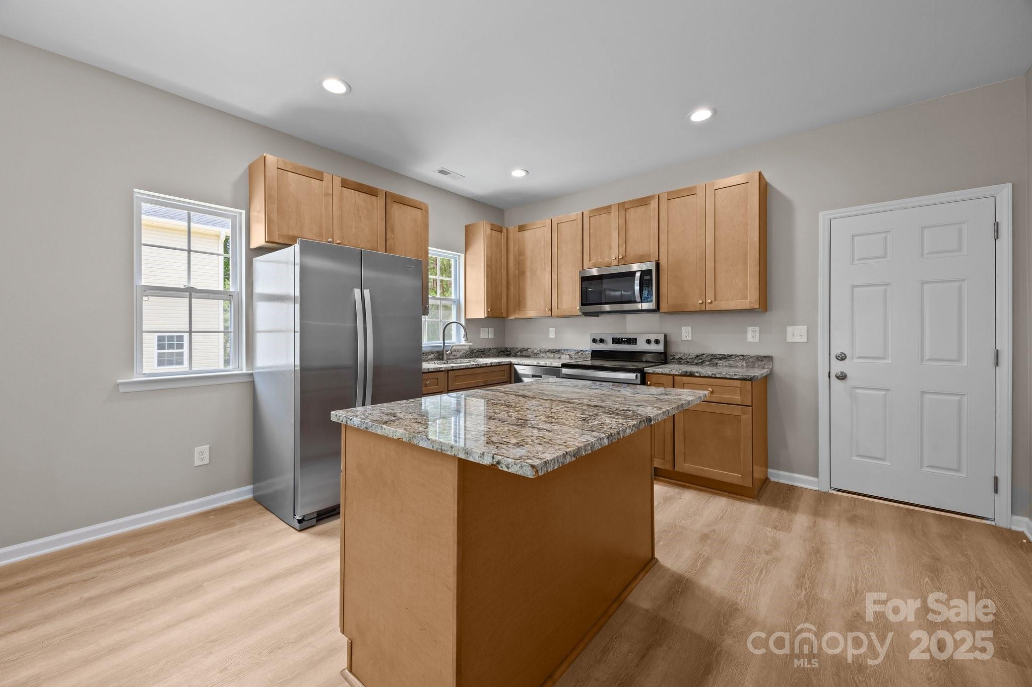 126 Aurora Boulevard Matthews, NC 28105 - Photo 8 of 41 a kitchen with stainless steel appliances granite countertop a refrigerator stove microwave and sink