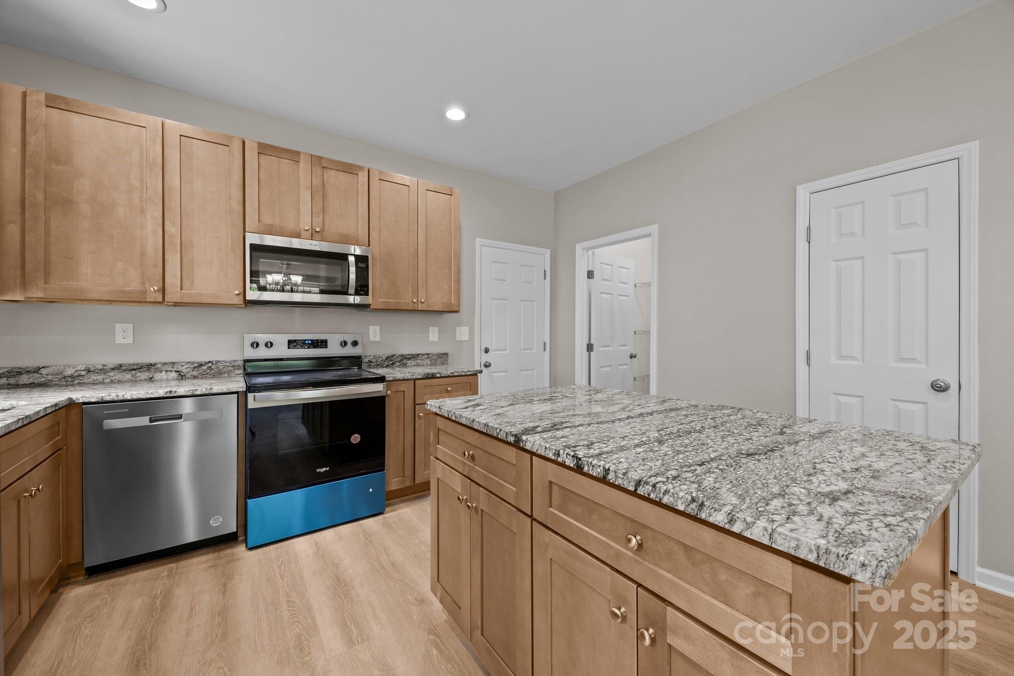 126 Aurora Boulevard Matthews, NC 28105 - Photo 9 of 41 a kitchen with stainless steel appliances granite countertop a stove sink and cabinets