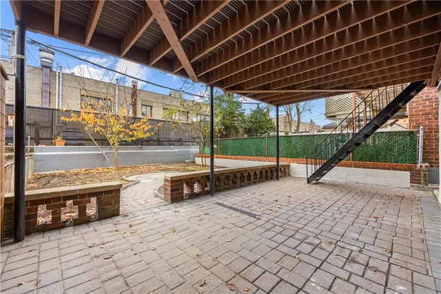 a view of a porch with furniture and a backyard