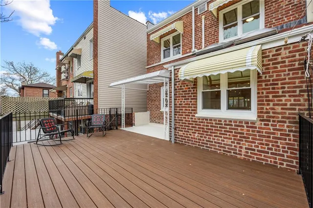 a front view of a house with a bench