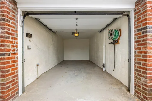 an aerial view of a building with garden space and parking