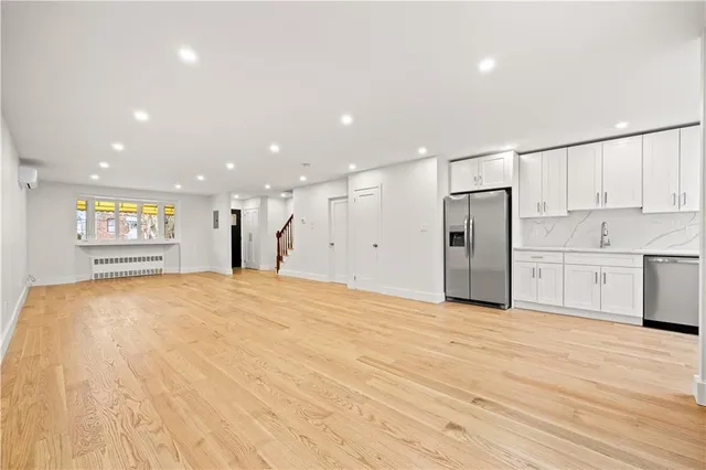 a view of an empty room with a kitchen