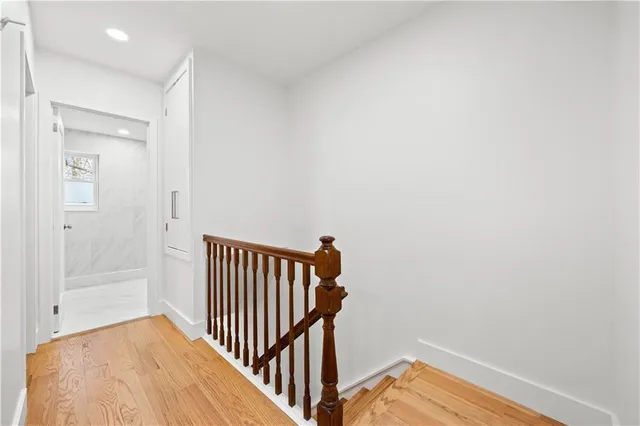 a view of hallway with wooden floor