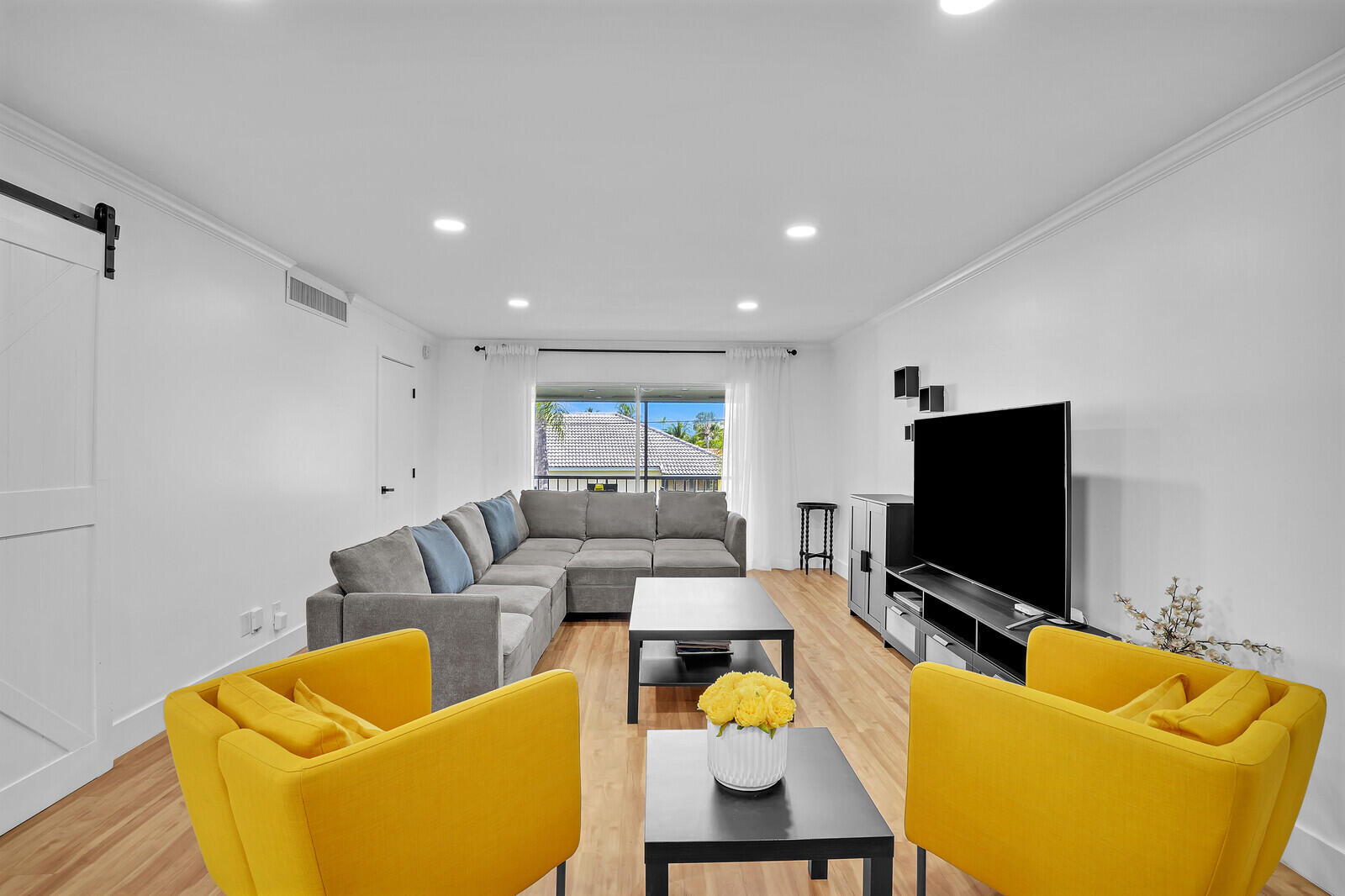 1210 Sugar Sands Boulevard, Unit 243 Singer Island, FL 33404 - Photo 13 of 55 a living room with furniture and a flat screen tv