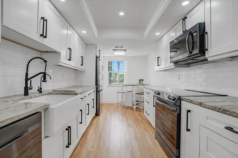 a kitchen with a sink and cabinets
