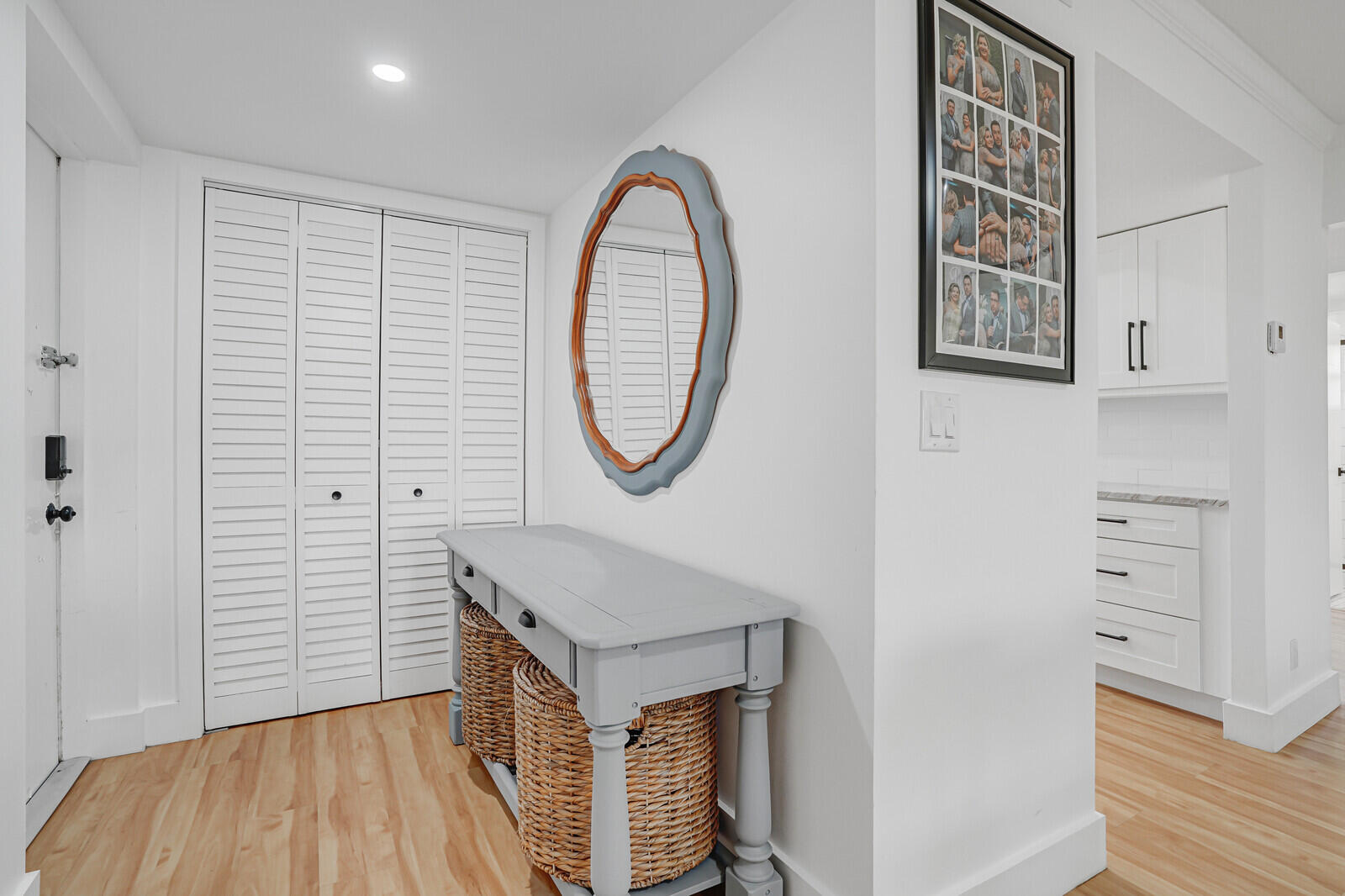 1210 Sugar Sands Boulevard, Unit 243 Singer Island, FL 33404 - Photo 3 of 55 a view of a hallway with entryway wooden floor and front door