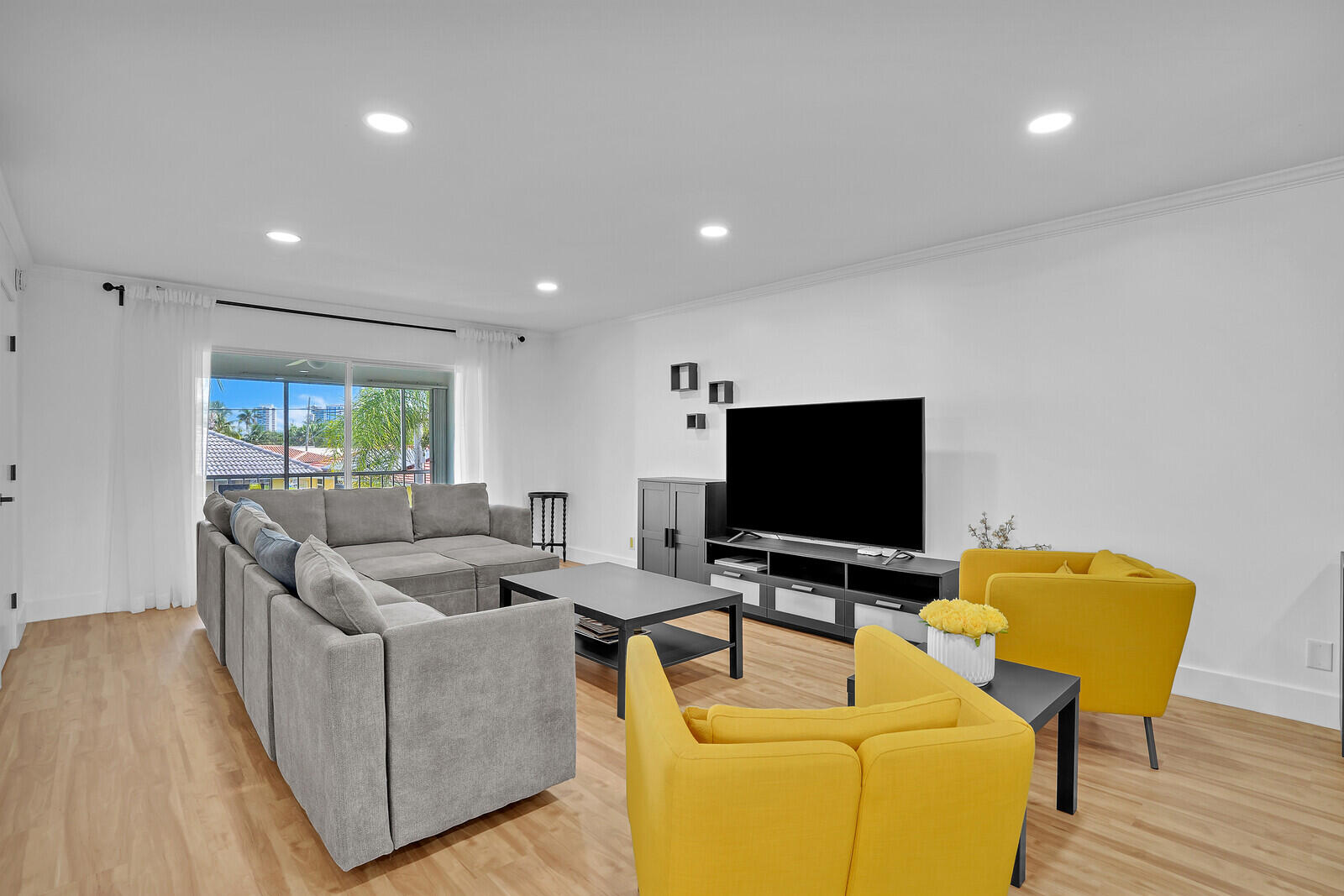 1210 Sugar Sands Boulevard, Unit 243 Singer Island, FL 33404 - Photo 8 of 55 a living room with furniture and a flat screen tv