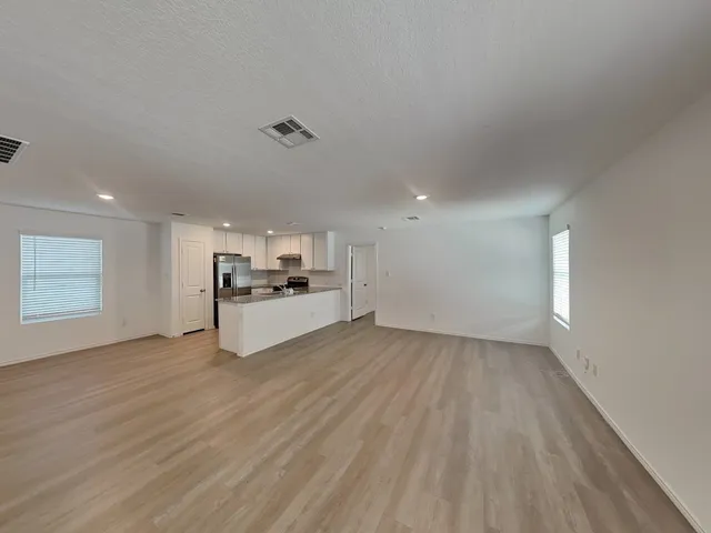 a view of a hallway with a kitchen