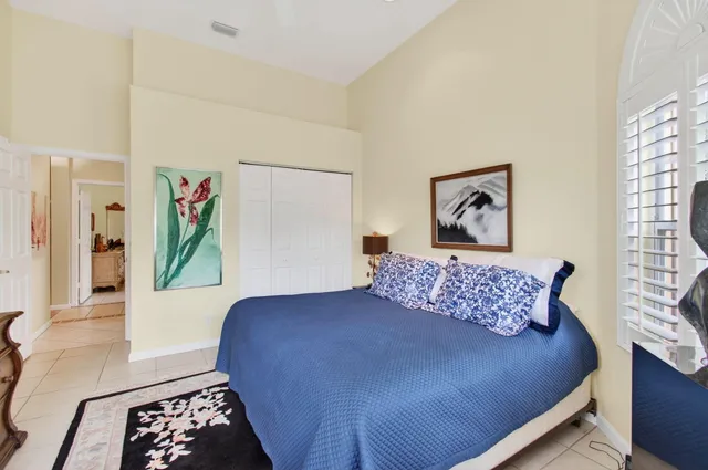 a bedroom with a bed and a painting on the wall