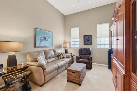 a living room with furniture and a lamp