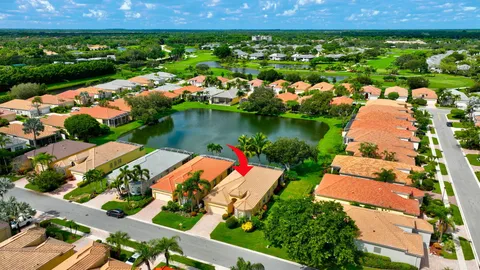 an aerial view of a house with a garden and lake view