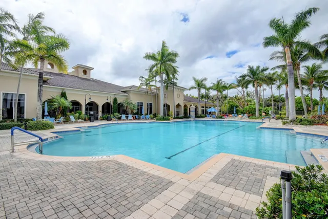 a view of swimming pool with outdoor seating and plants