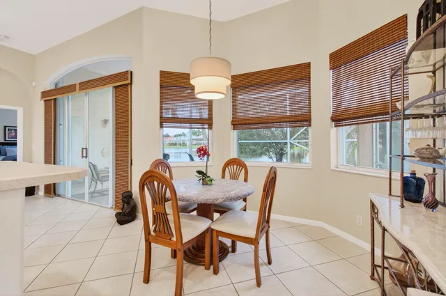 a dining room with furniture a chandelier and window