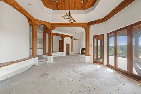 a large bedroom with a bed and a large window with the balcony view