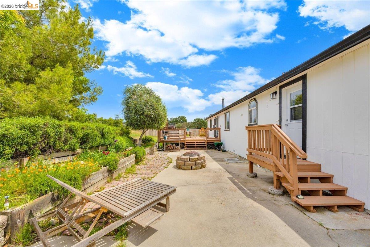 4419 Little John Road Copperopolis, CA 95228 - Photo 21 of 43 Expansive concrete patio area featuring a stone fire pit