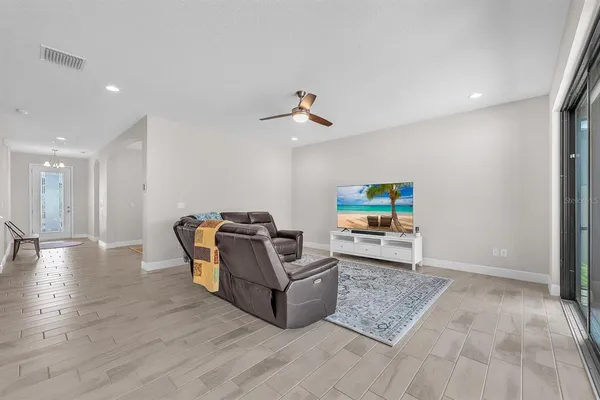 a living room with furniture and a floor to ceiling window