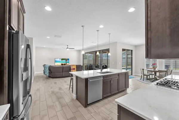 a large kitchen with a table and chairs