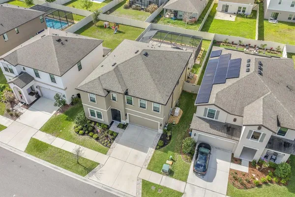 an aerial view of a house with a yard