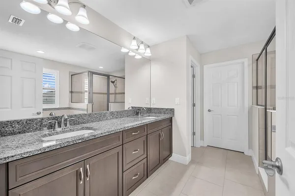 a bathroom with a tub shower and sink