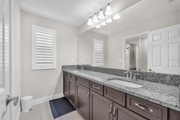 a bedroom with a bed and a ceiling fan