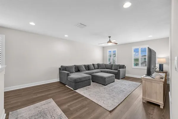a living room with furniture and kitchen view