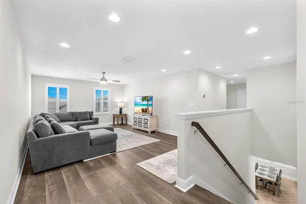 a dining room with furniture and a floor to ceiling window