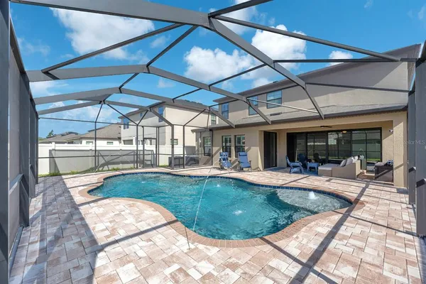 a view of yard with swimming pool and garden