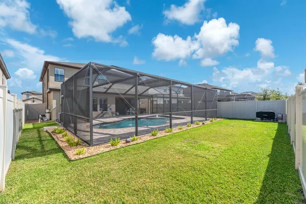 a view of backyard with deck and garden