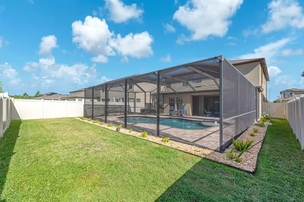 an aerial view of a house with a yard