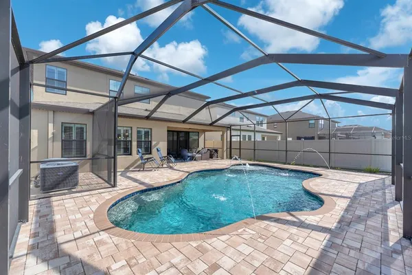 a front view of a house with a garden and plants