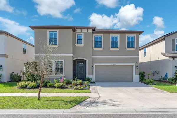 a view of a hallway with wooden floor and a bathroom