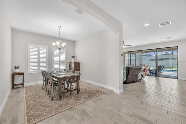 a view of a dining room with furniture and wooden floor