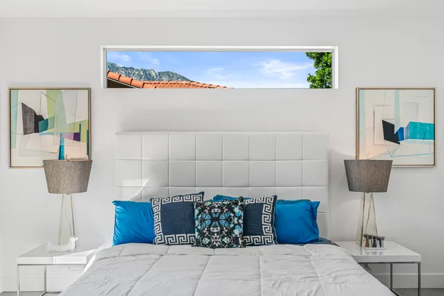 a bedroom with a bed and a table