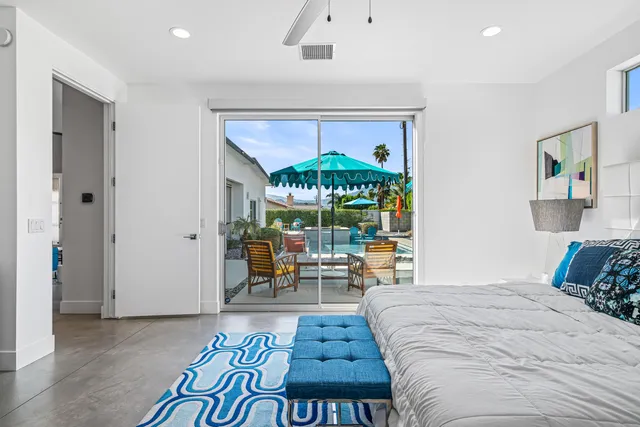 a bedroom with two beds and a chandelier