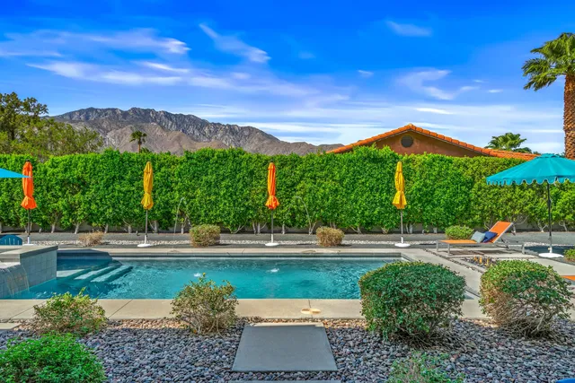 a view of a patio with swimming pool table and chairs